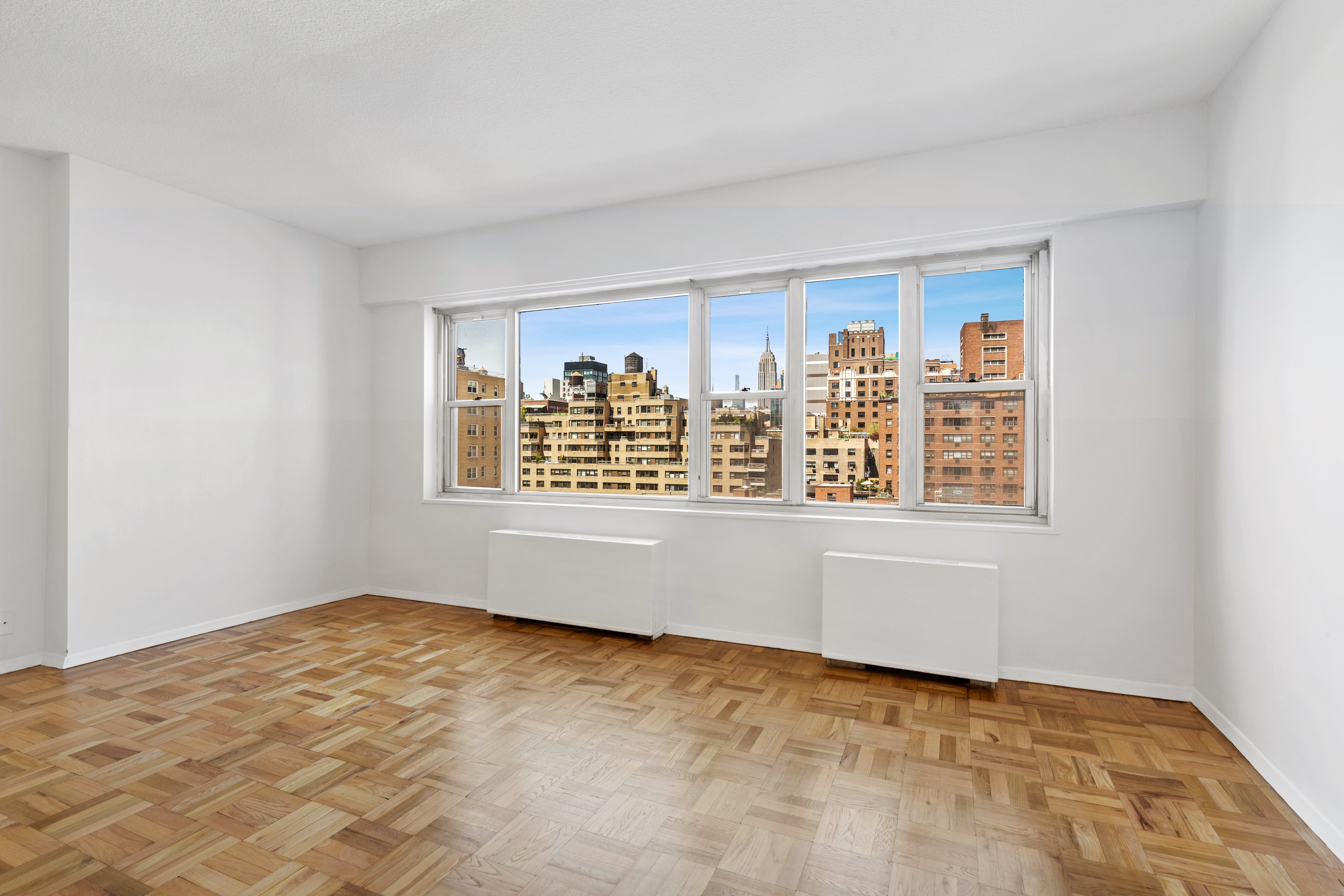60 East 8th Street, Unit 9J Manhattan, NY 10003 - Photo 3 of 13 a view of an empty room with a window