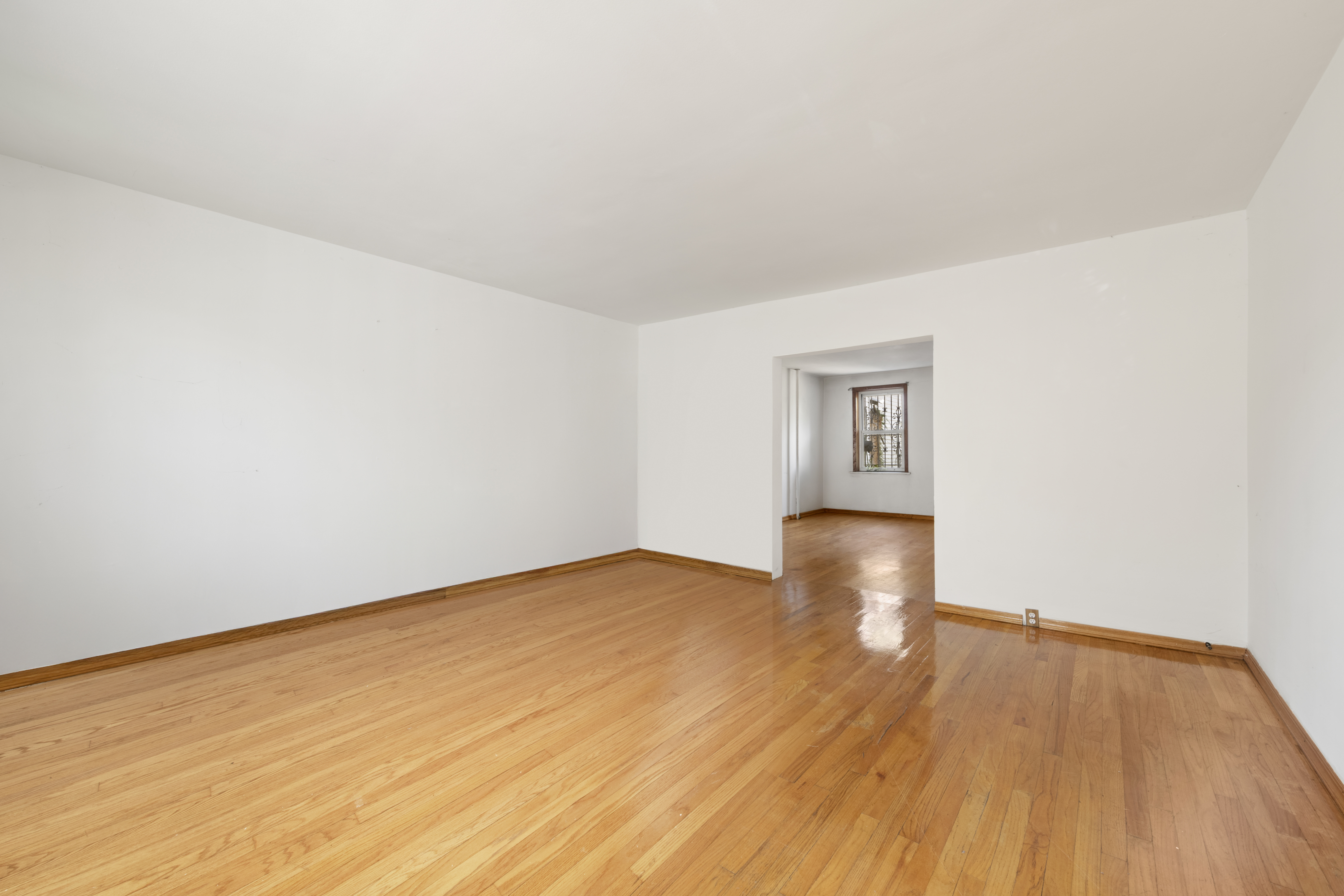 37-34 28th Street Queens, NY 11101 - Photo 4 of 17 an empty room with wooden floor and natural light