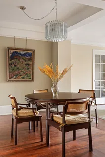 a view of a dining room with furniture and chandelier