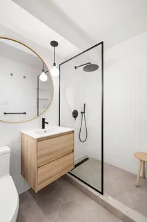 a bathroom with a sink a toilet and shower