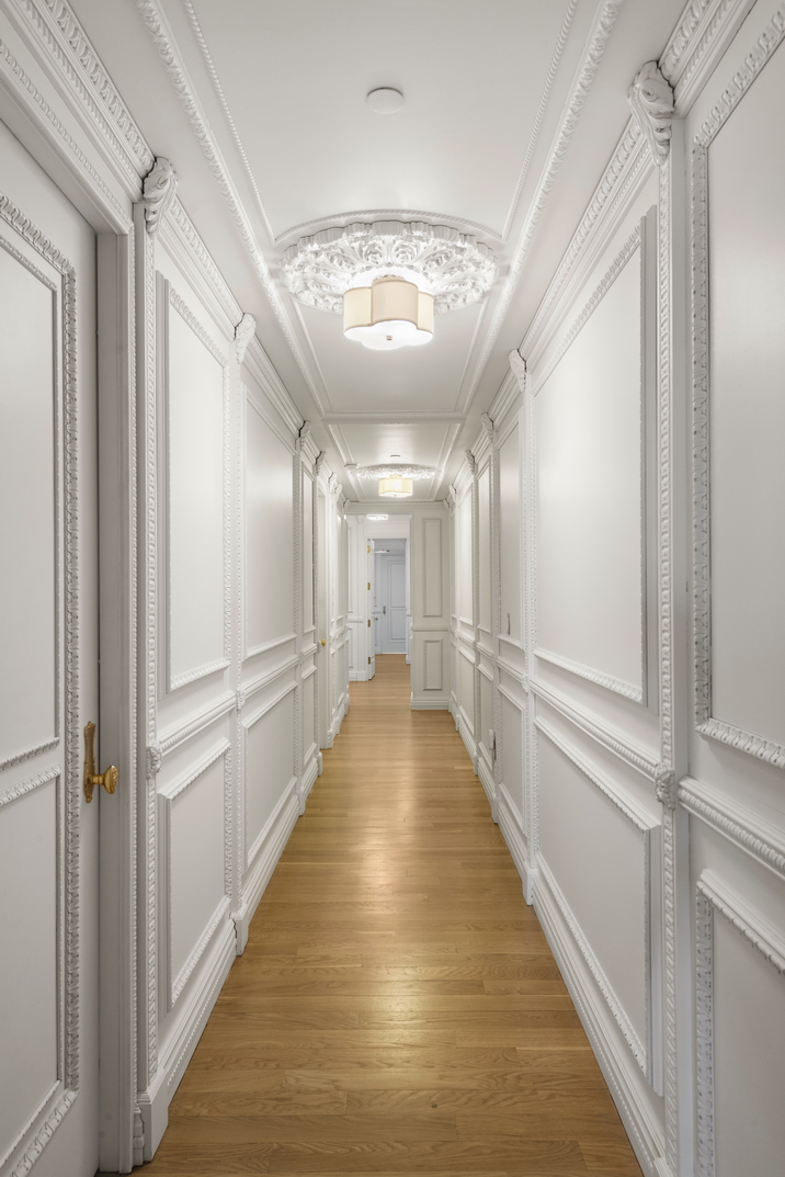 1 Central Park South, Unit 1801 Manhattan, NY 10019 - Photo 12 of 25 a view of a hallway with wooden floor and staircase