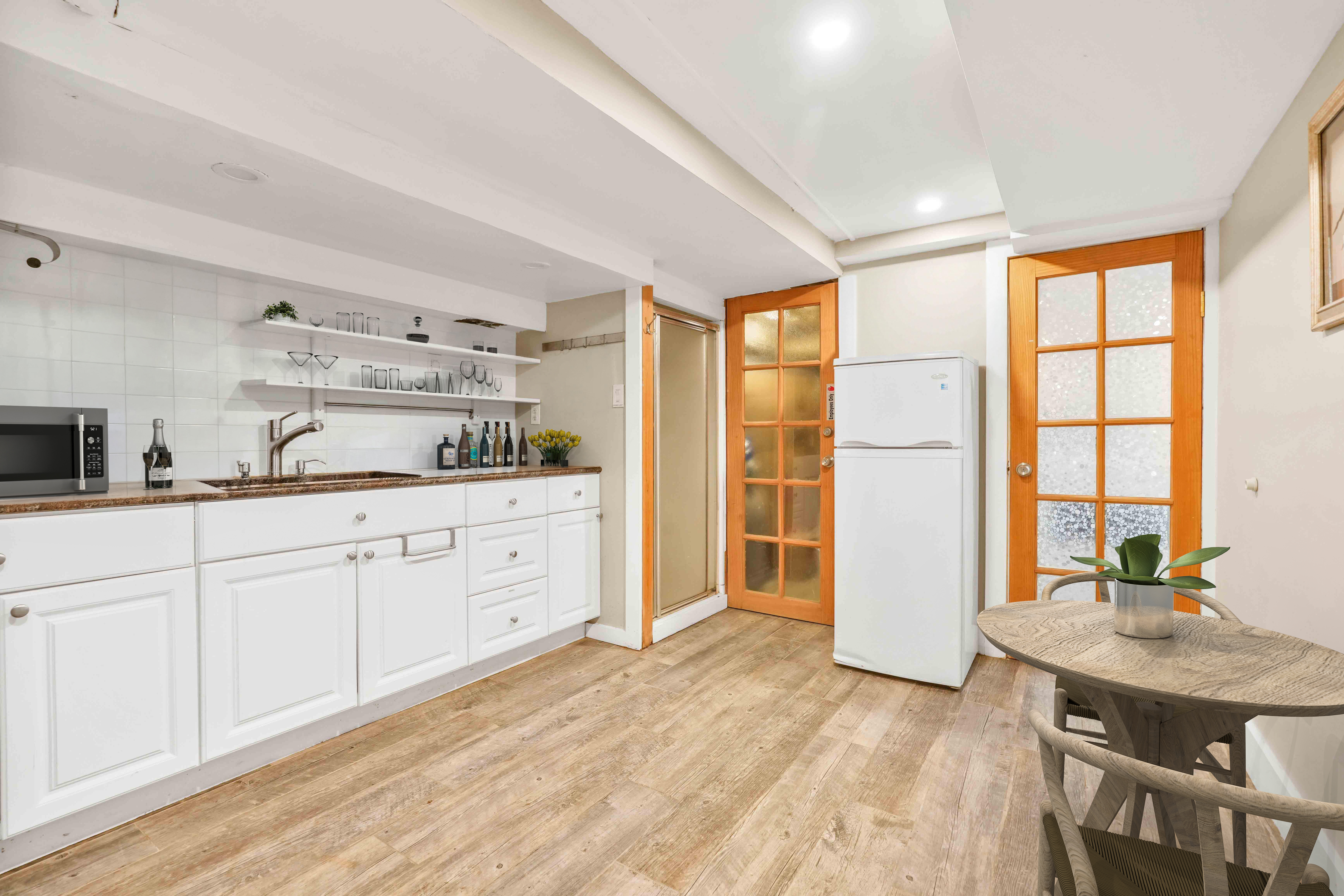 288 St James Place, Unit TRIPLEX Brooklyn, NY 11238 - Photo 20 of 25 a kitchen with stainless steel appliances kitchen island granite countertop a refrigerator a sink dishwasher and white cabinets with wooden floor