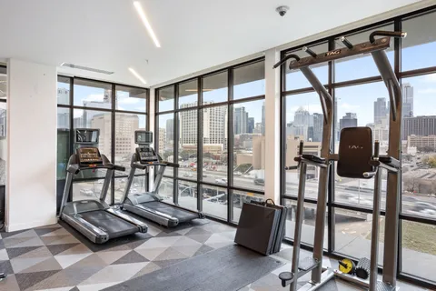 a living room with furniture and floor to ceiling windows