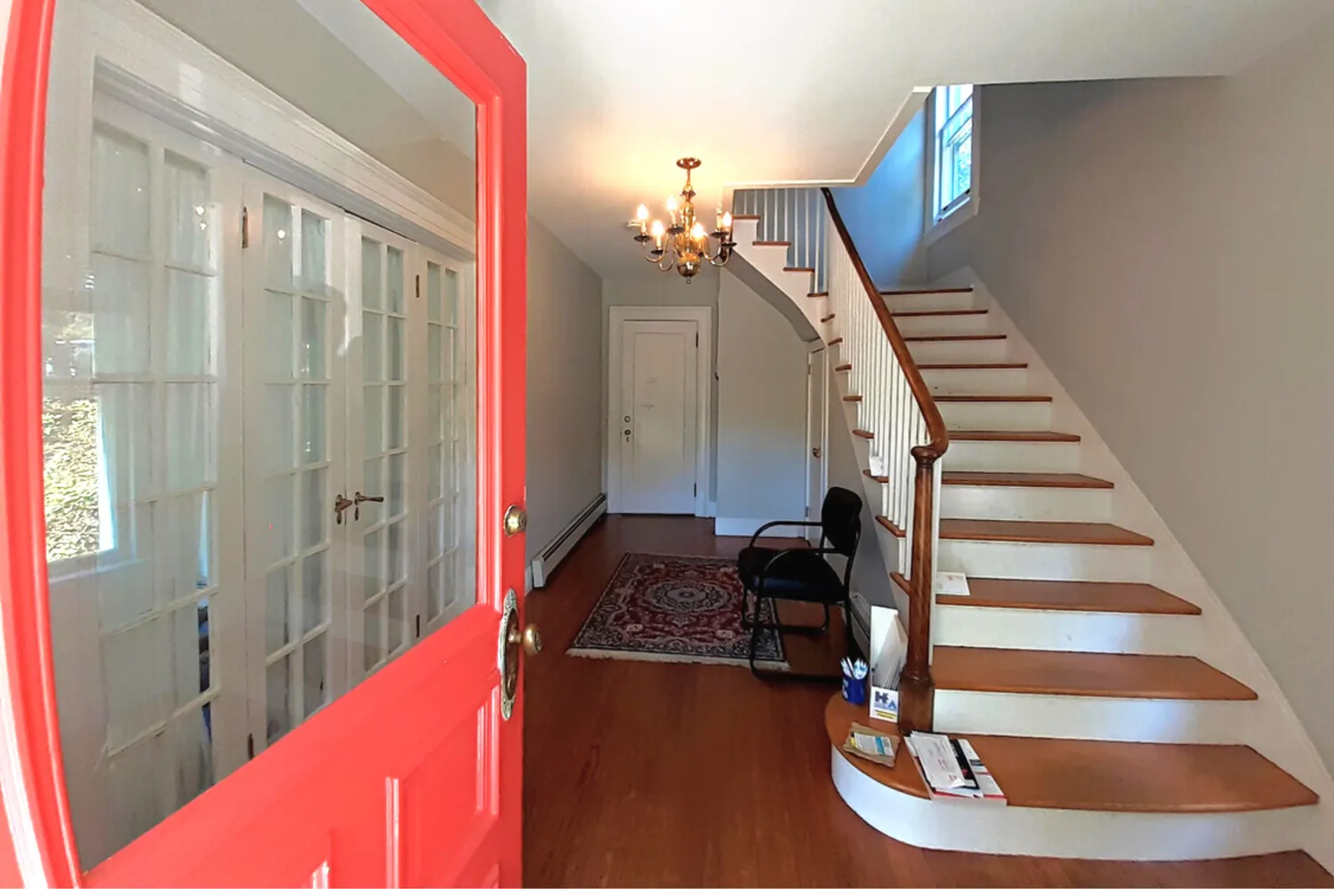 a view of entryway and hall with wooden floor