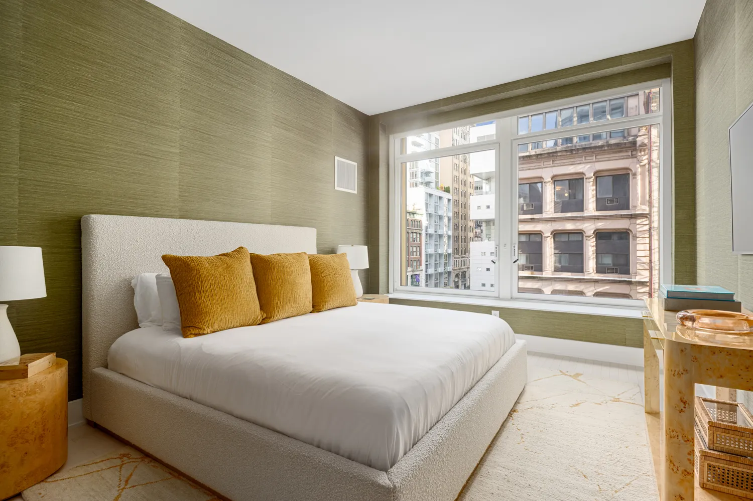 a bedroom with a large bed and a large window