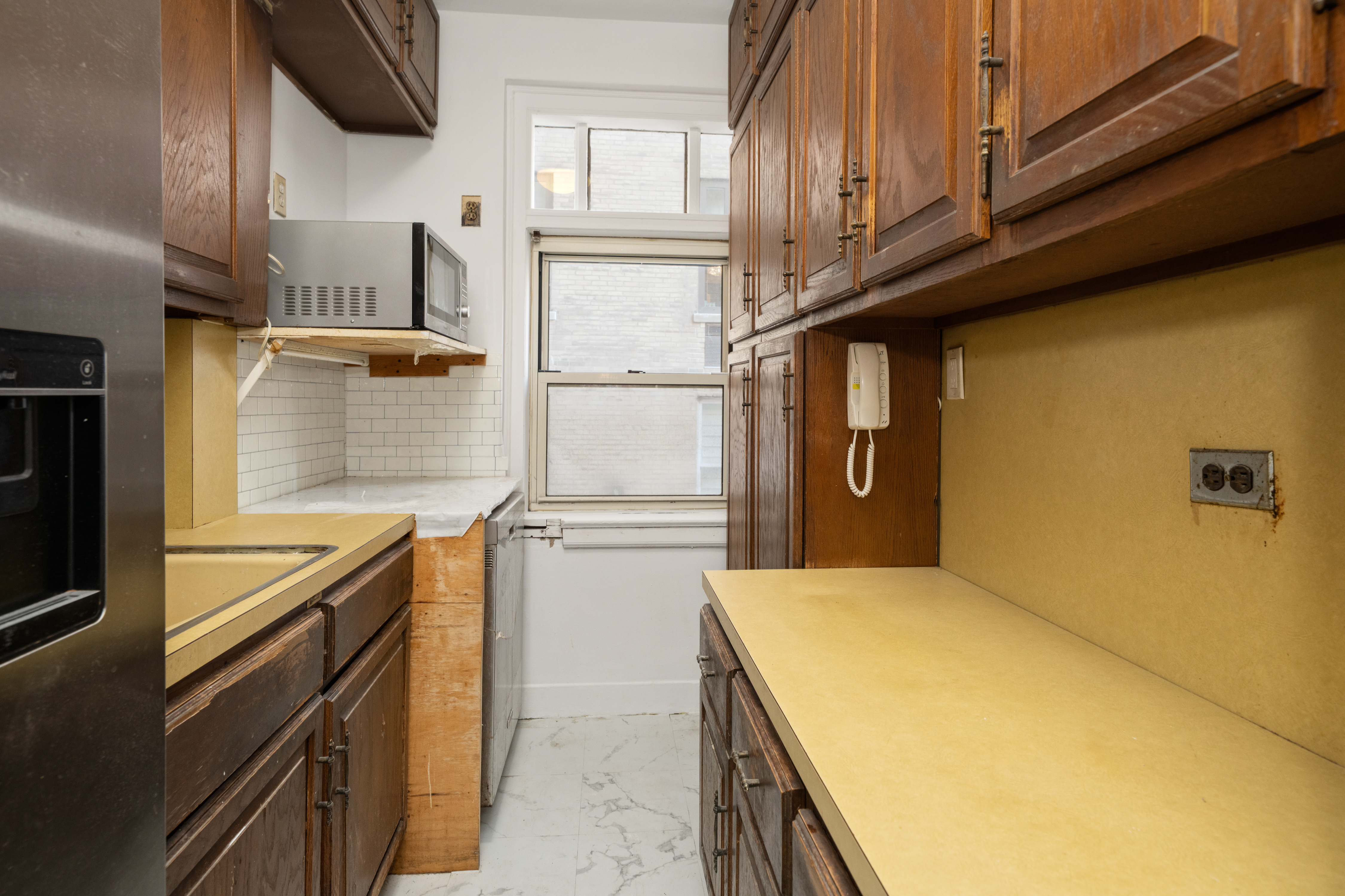 44 Gramercy Park North, Unit 5F Manhattan, NY 10010 - Photo 6 of 10 a kitchen with stainless steel appliances granite countertop a sink and cabinets