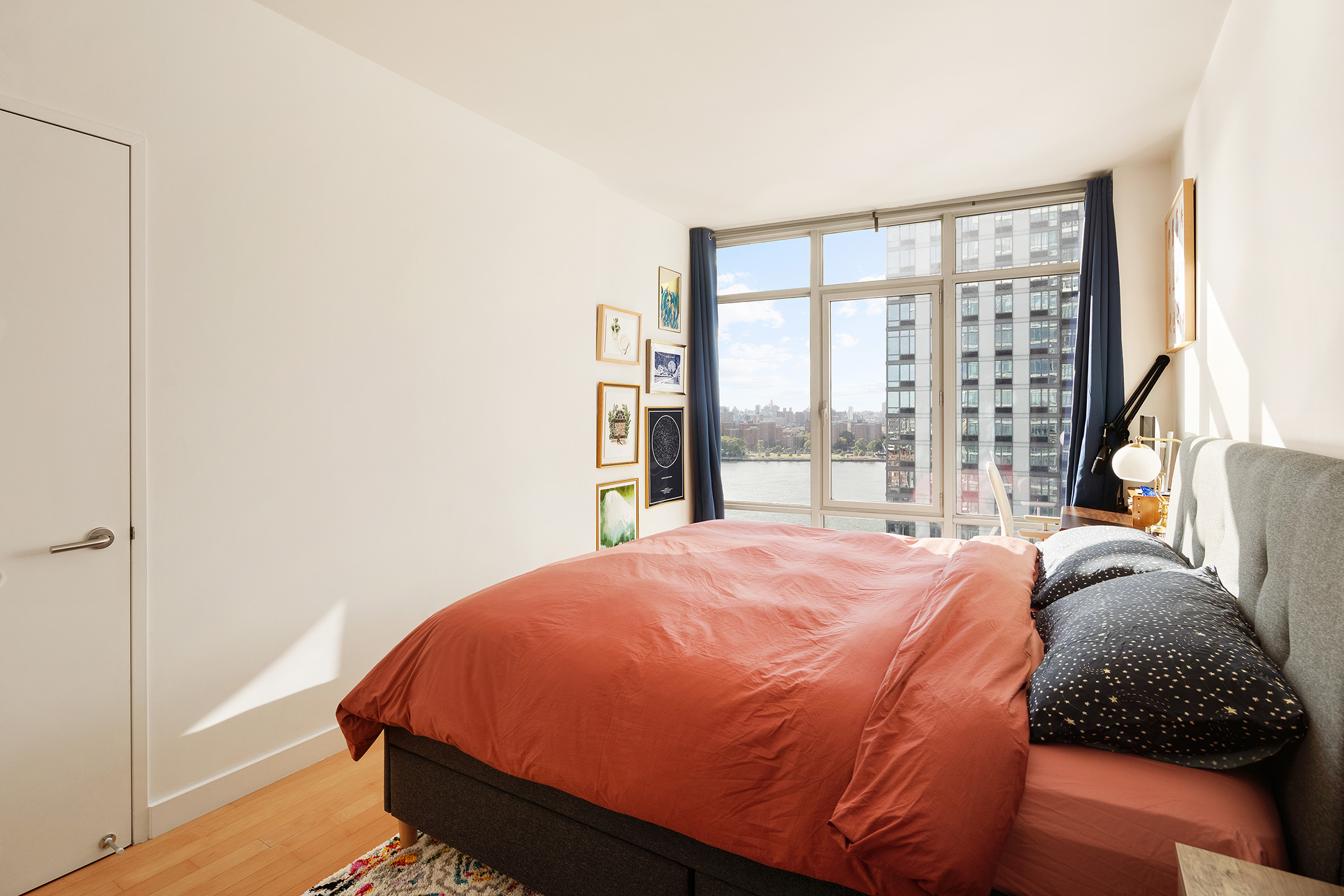1 Northside Piers, Unit 18C Brooklyn, NY 11249 - Photo 4 of 12 a bed sitting in a bedroom next to a window