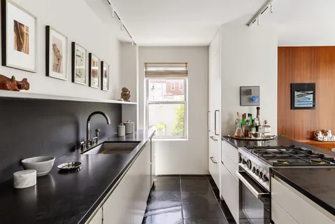 a kitchen that has a sink and a stove