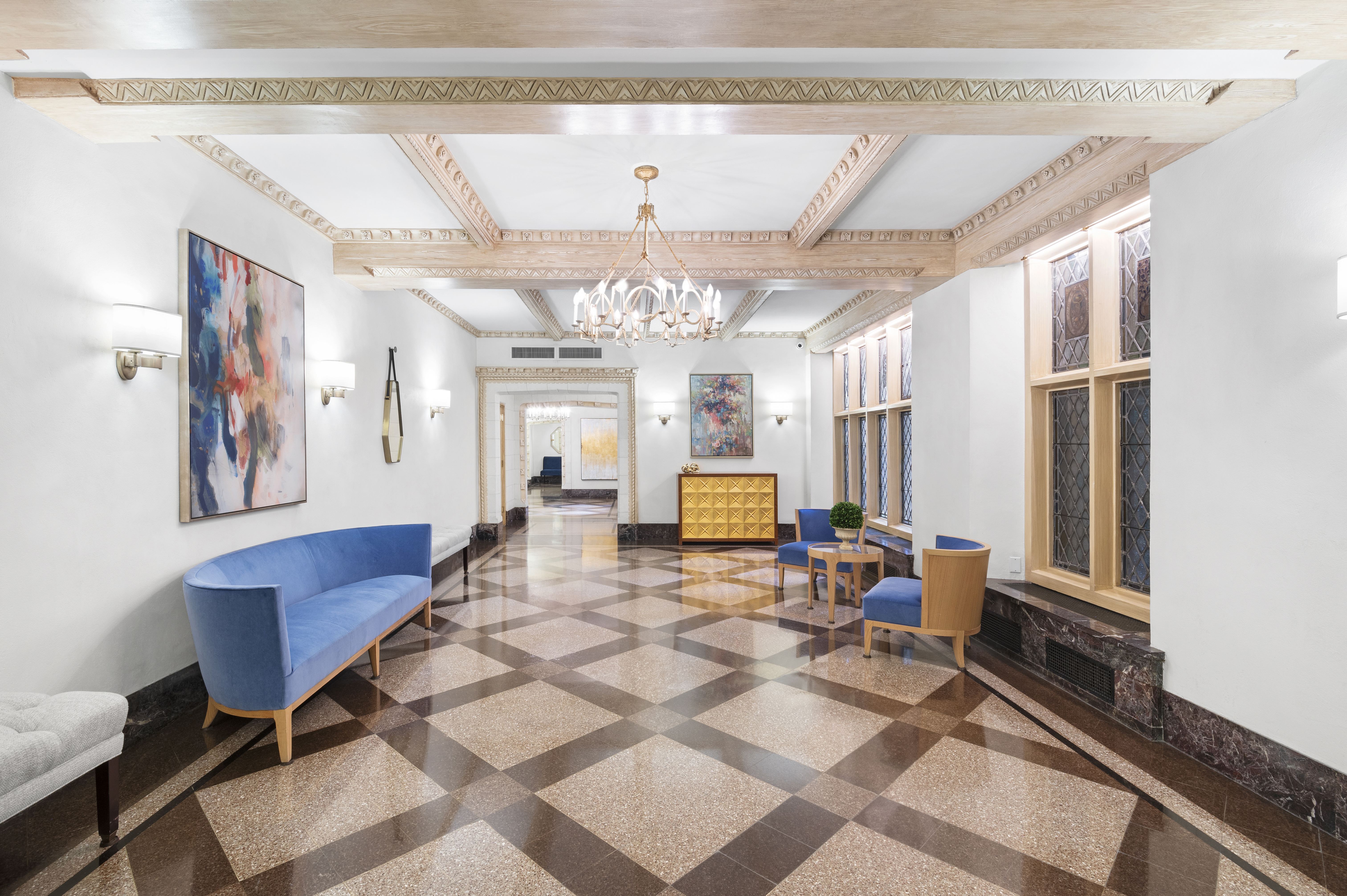 975 Park Avenue, Unit 1CD Manhattan, NY 10028 - Photo 9 of 14 a living room with furniture and a chandelier