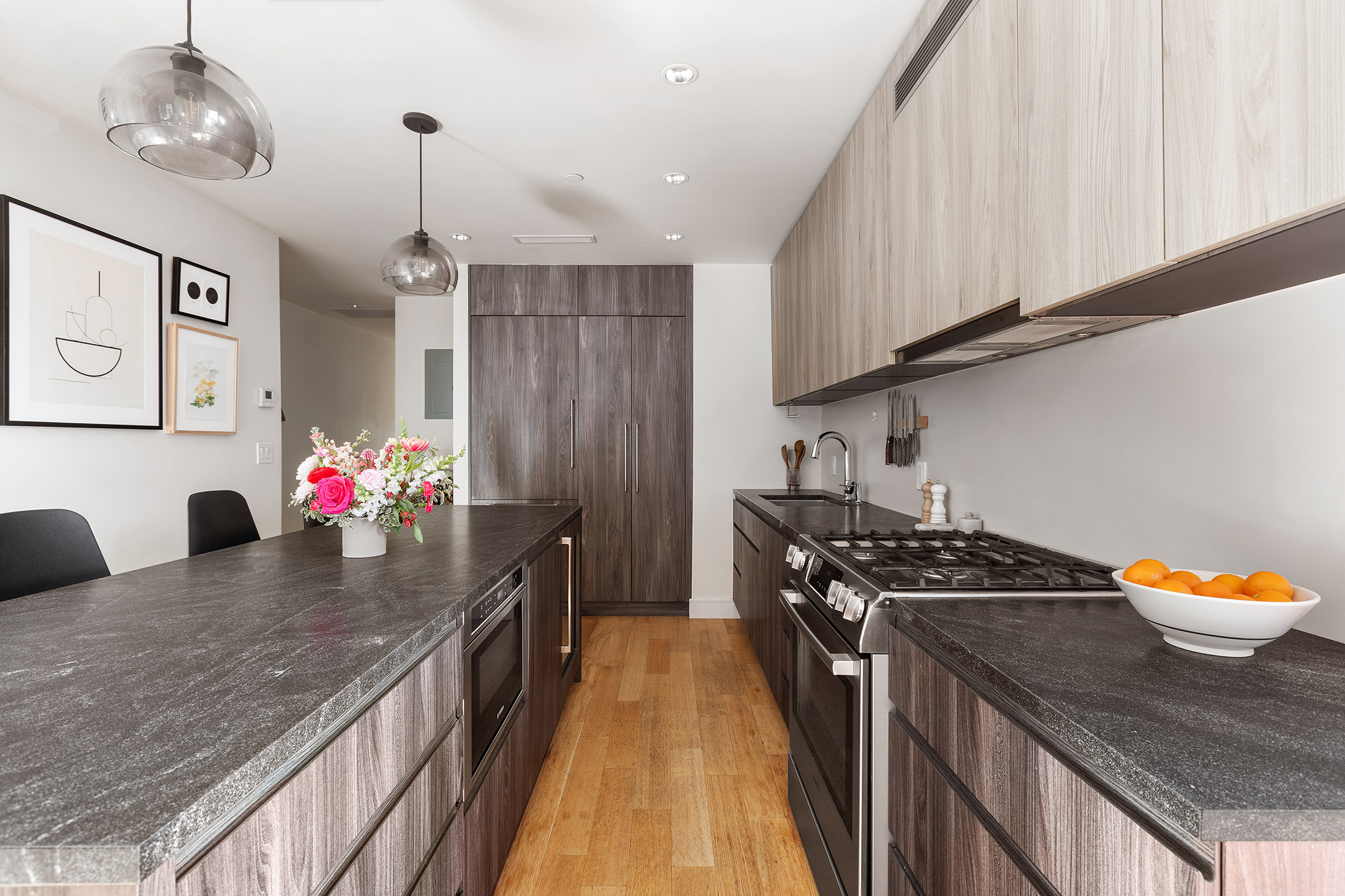 868 Lorimer Street, Unit 4C Brooklyn, NY 11222 - Photo 4 of 14 a kitchen with stainless steel appliances granite countertop a sink a stove and a wooden floors