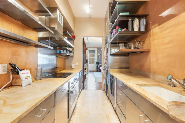a view of a kitchen with a sink and cabinets