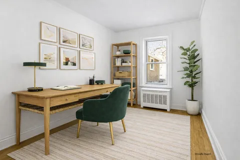 a living room with furniture wooden floor and a potted plant