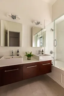 a spacious bathroom with a double vanity sink mirror double and bathtub