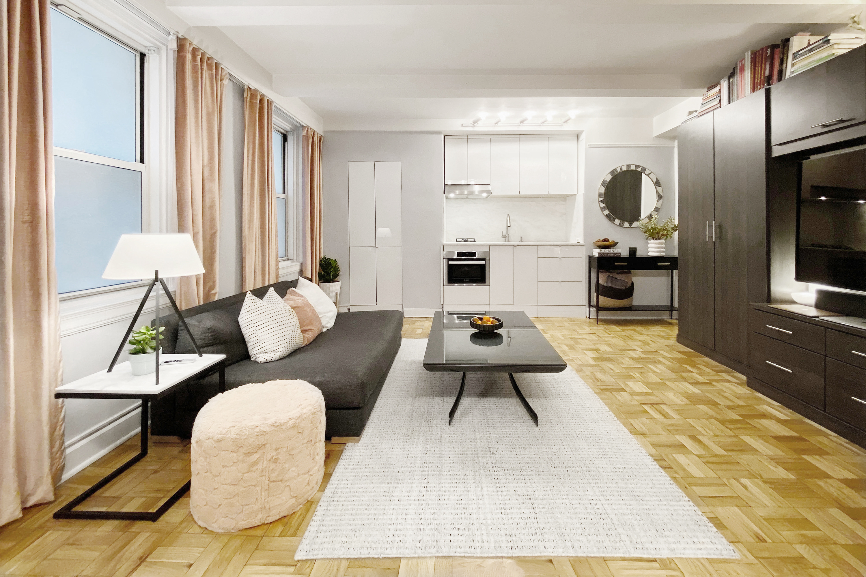 a living room with furniture rug and wooden floor