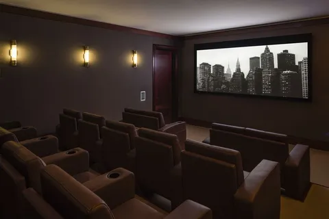 a media room with lots of chairs and a projector