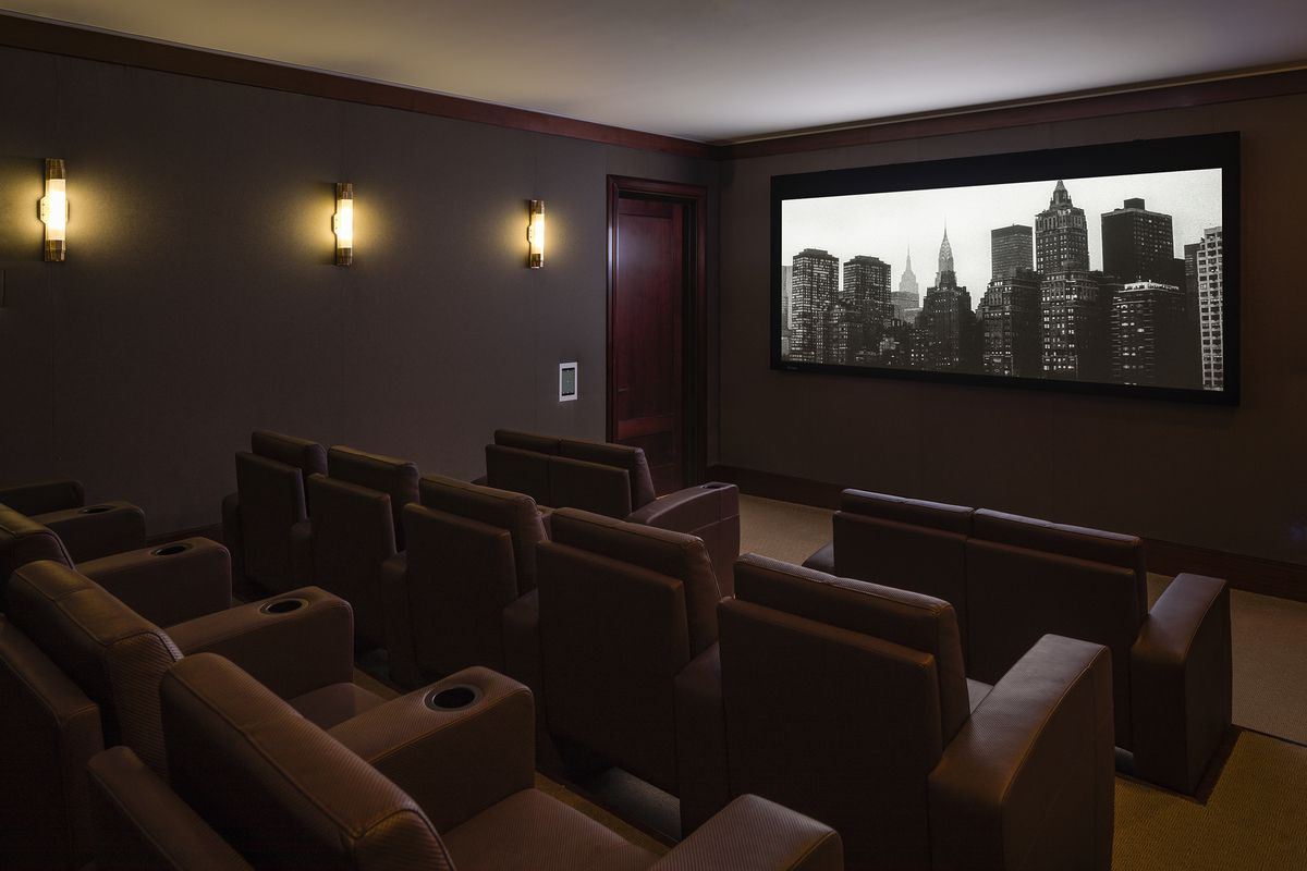 150 West 12th Street, Unit 3W Manhattan, NY 10011 - Photo 25 of 27 a media room with lots of chairs and a projector