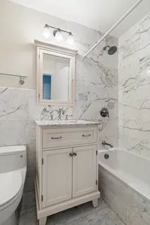 a bathroom with a sink a toilet and bathtub