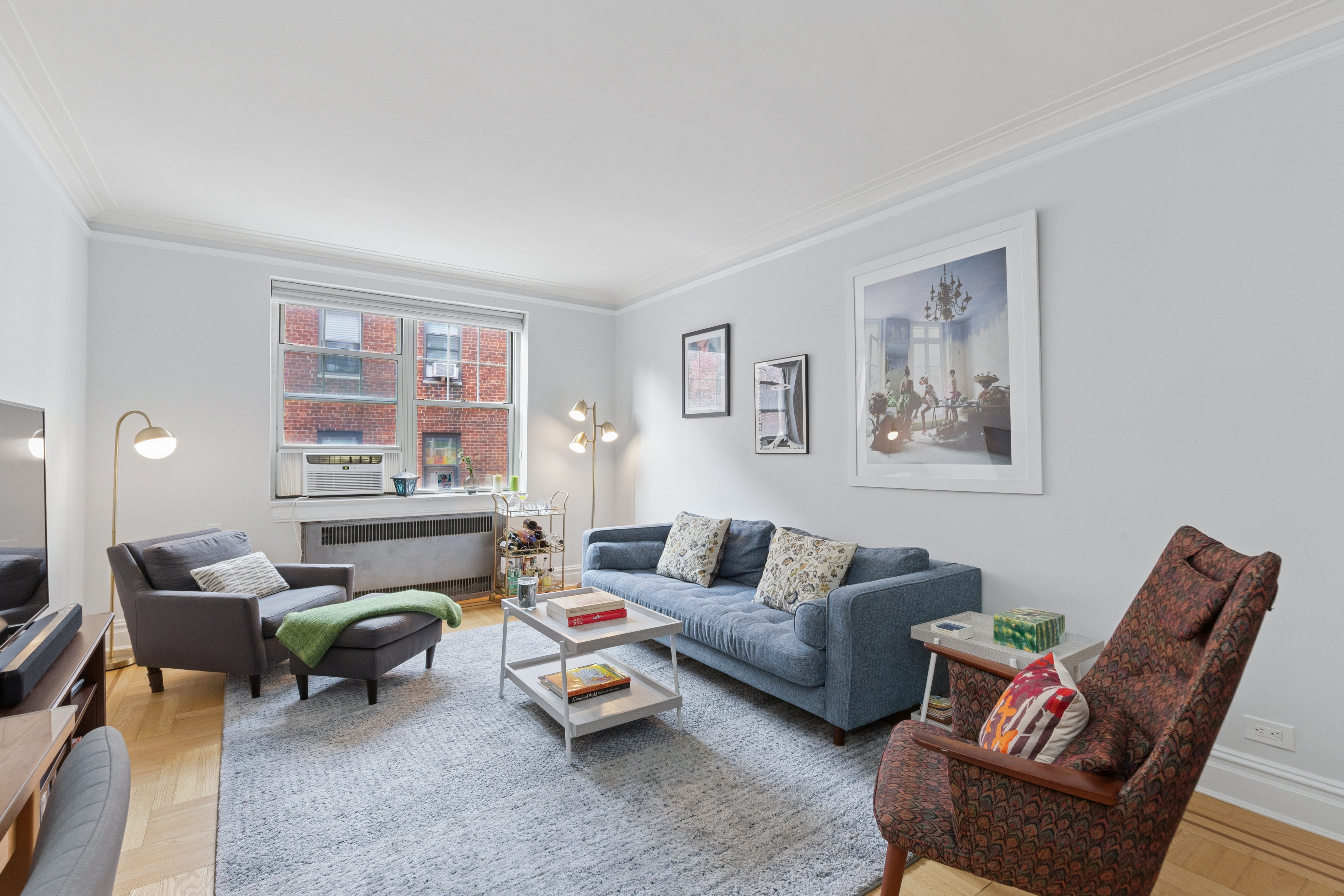 a living room with furniture and wooden floor