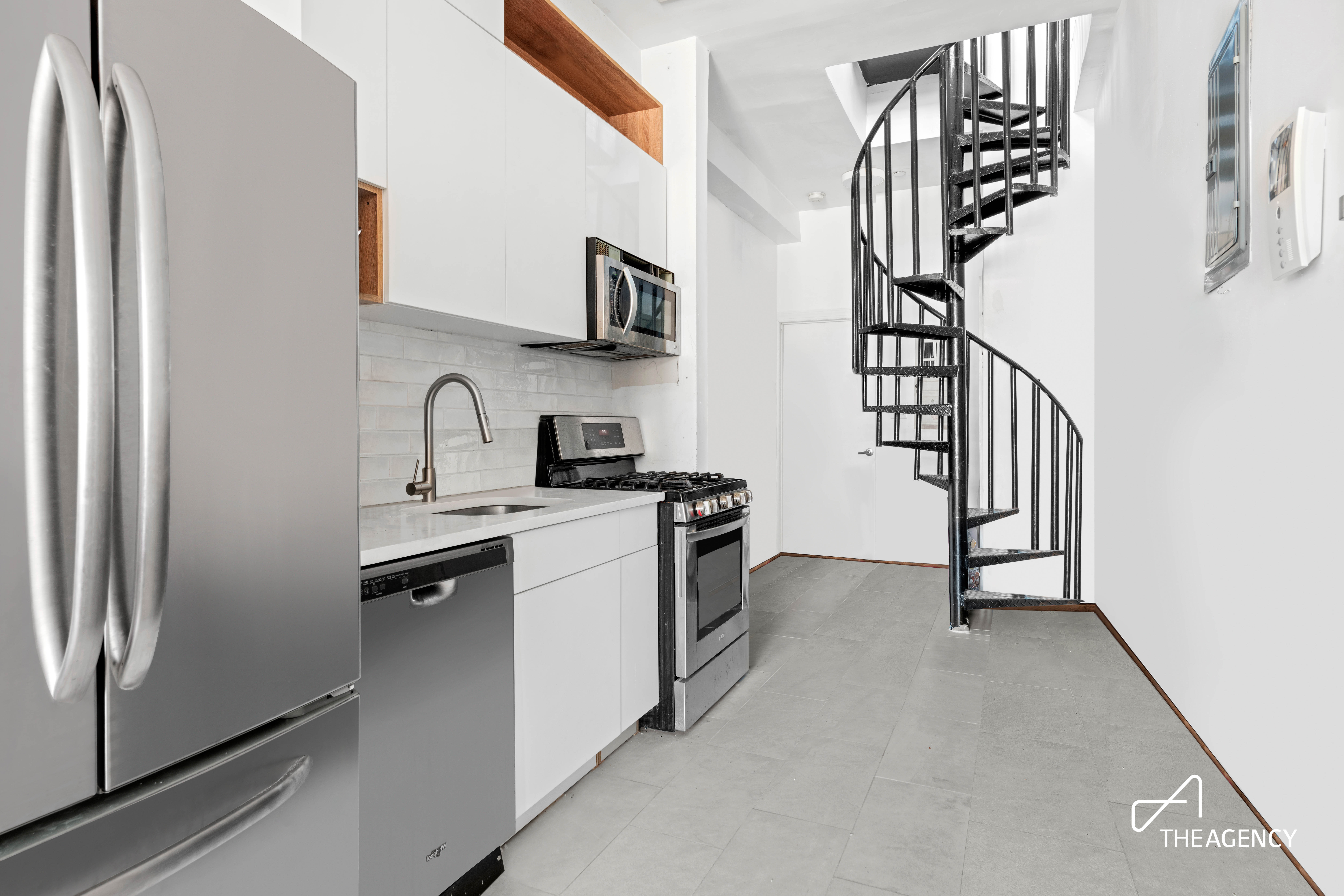 221 Troutman Street, Unit 4L Brooklyn, NY 11237 - Photo 2 of 11 a kitchen with white cabinets and stainless steel appliances