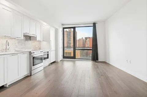 a kitchen with wooden floors and white appliances