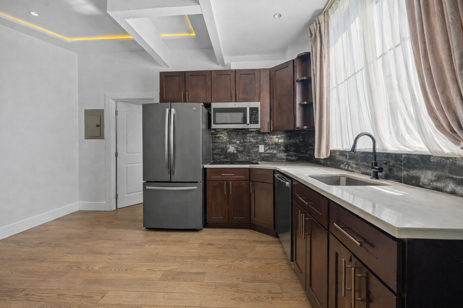 83 Suydam Street, Unit TWOFAMILY Brooklyn, NY 11221 - Photo 5 of 11 a kitchen with a sink a refrigerator and a stove top oven