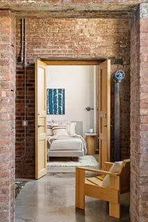 a bedroom with a bed dresser and a window