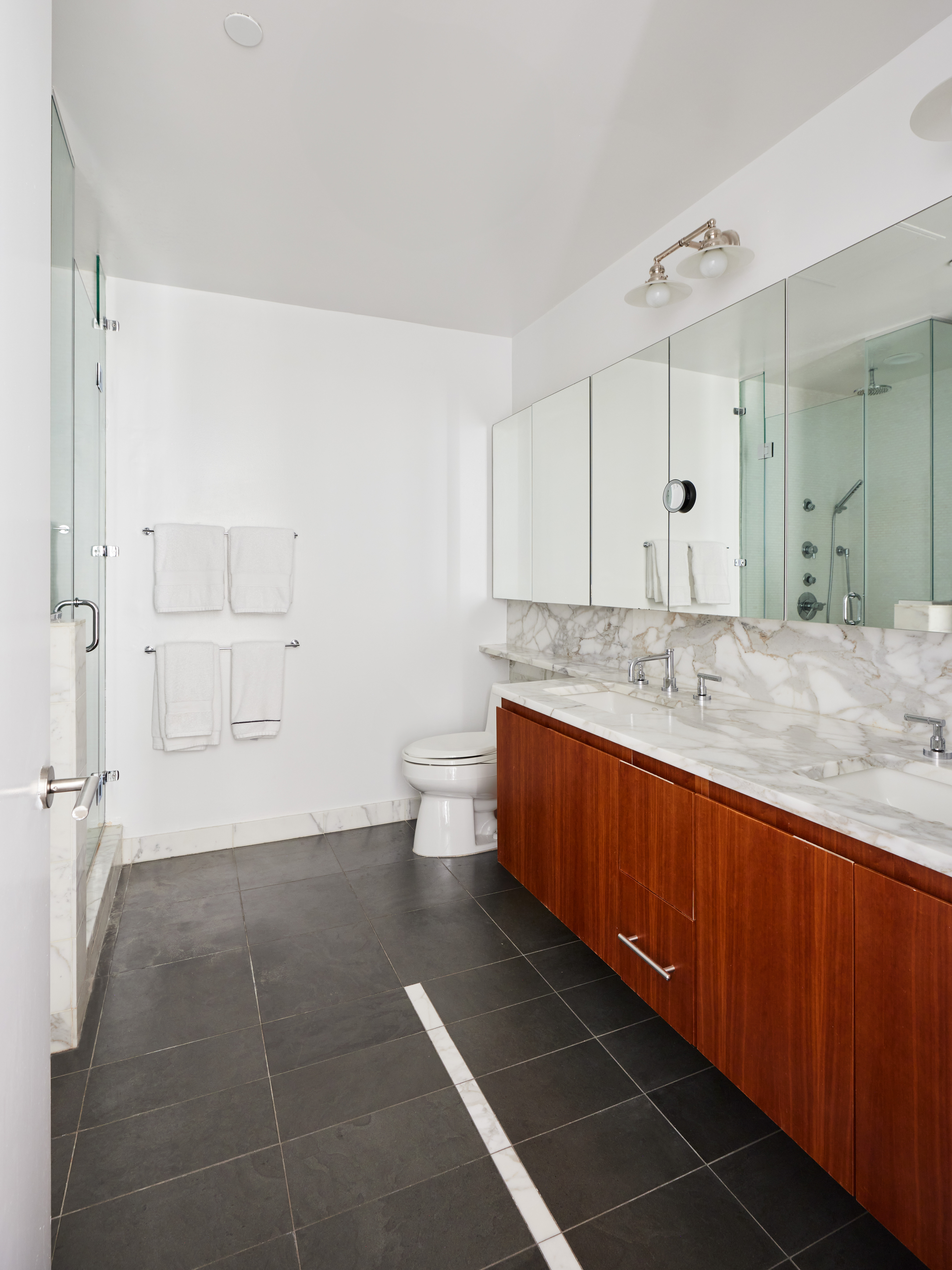 505 Greenwich Street, Unit 14A Manhattan, NY 10013 - Photo 12 of 20 a spacious bathroom with a granite countertop sink a toilet and shower