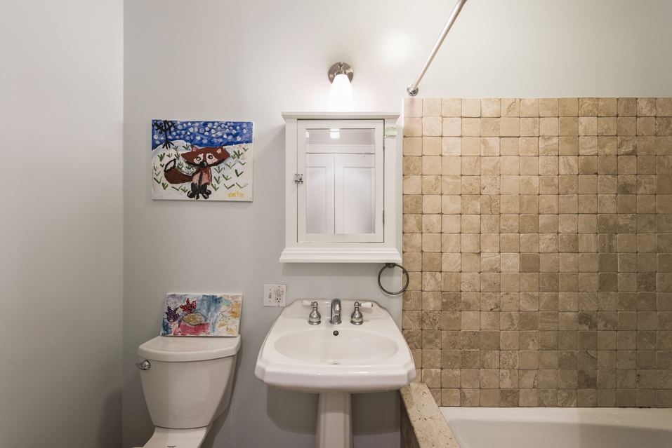 369 6th Avenue, Unit 2 Brooklyn, NY 11215 - Photo 6 of 9 a bathroom with a sink mirror and toilet