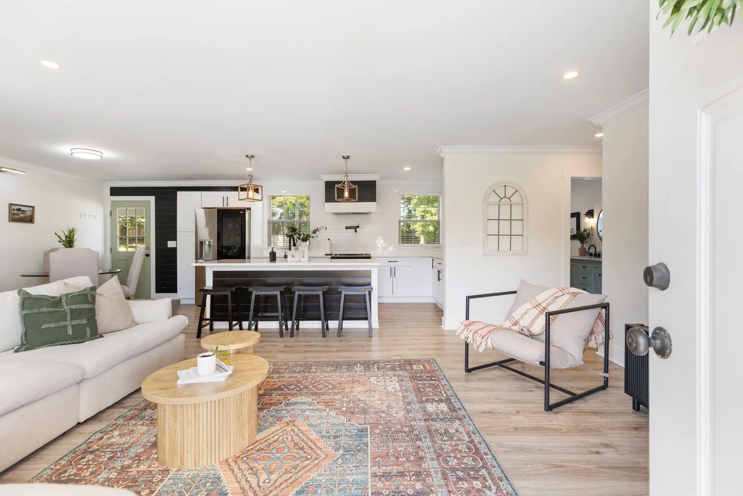 a living room with furniture and a flat screen tv with wooden floor