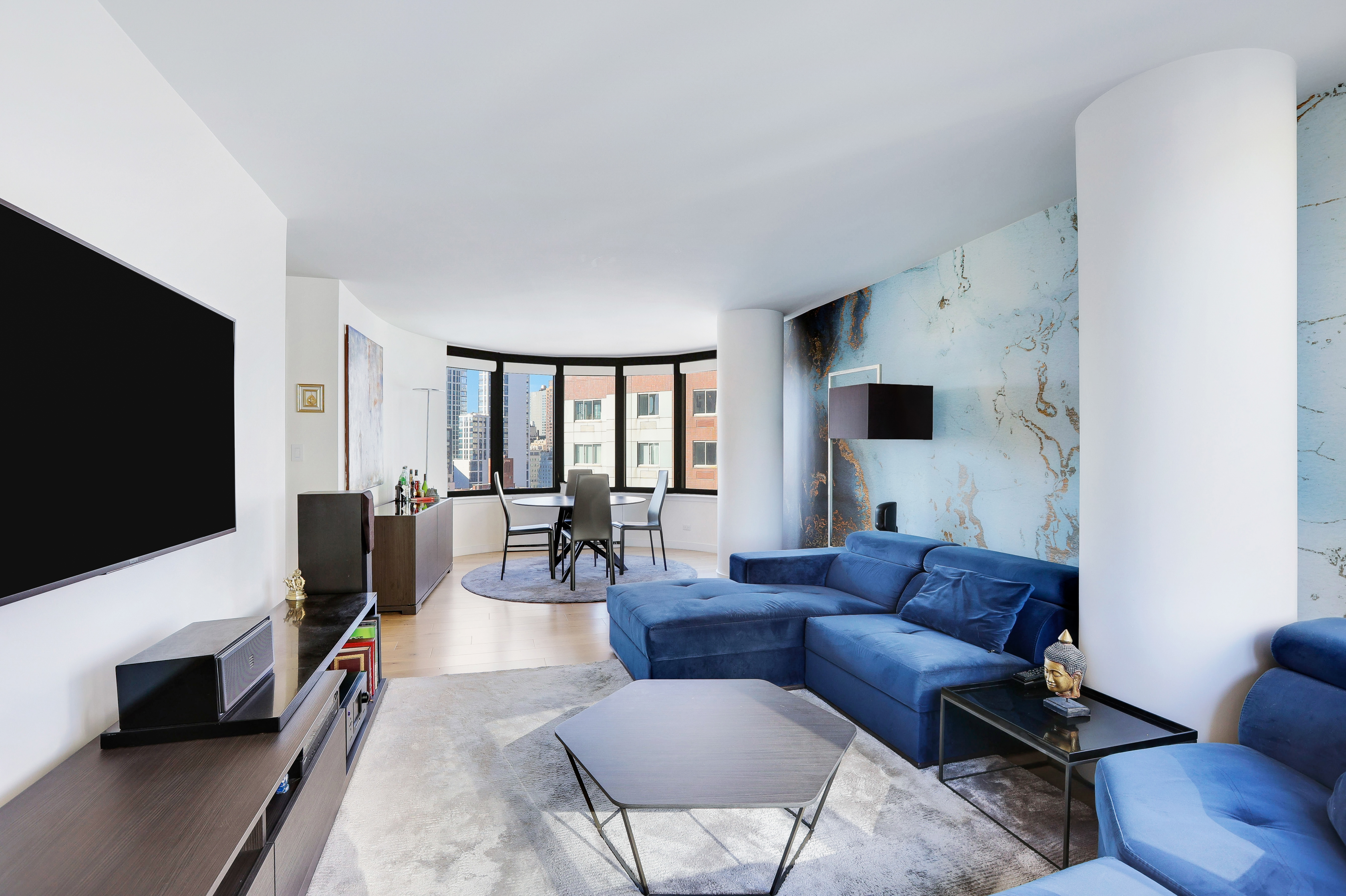 330 East 38th Street, Unit 20E Manhattan, NY 10016 - Photo 3 of 17 a living room with furniture and a flat screen tv