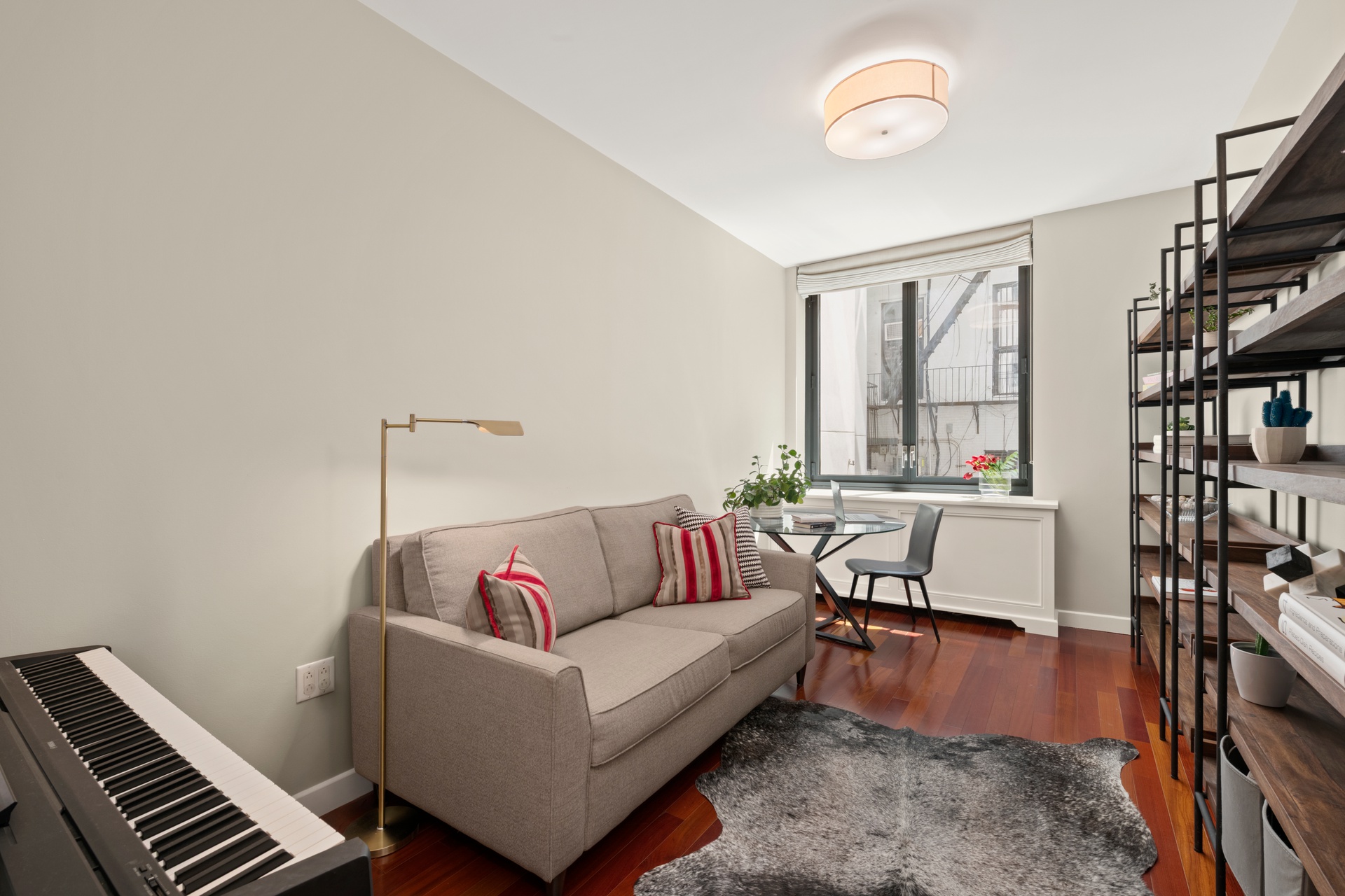 50 West 15th Street, Unit 2D Manhattan, NY 10011 - Photo 8 of 15 a living room with furniture and a book shelf