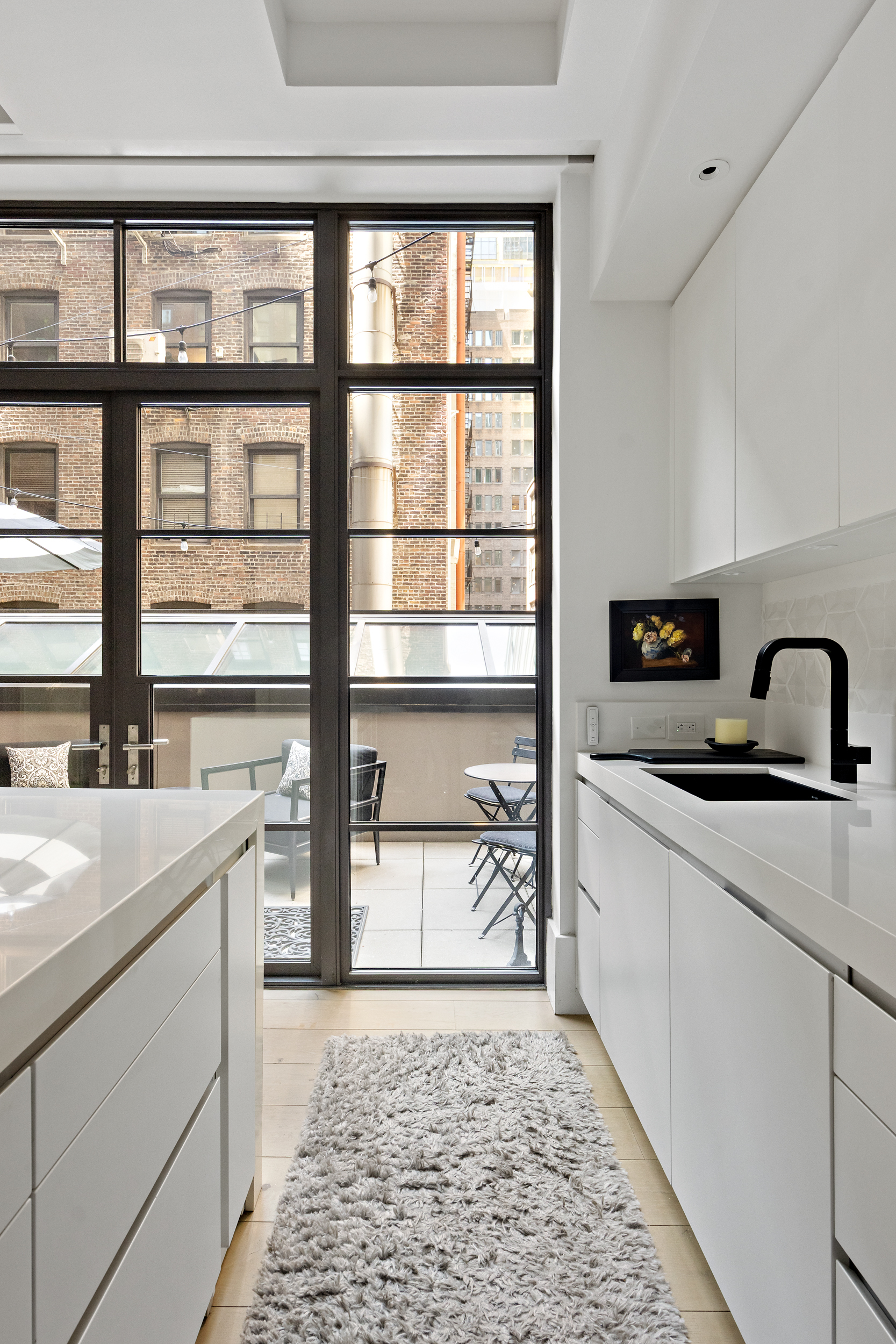404 Park Avenue South, Unit 3E Manhattan, NY 10016 - Photo 10 of 21 a kitchen with a sink and a refrigerator