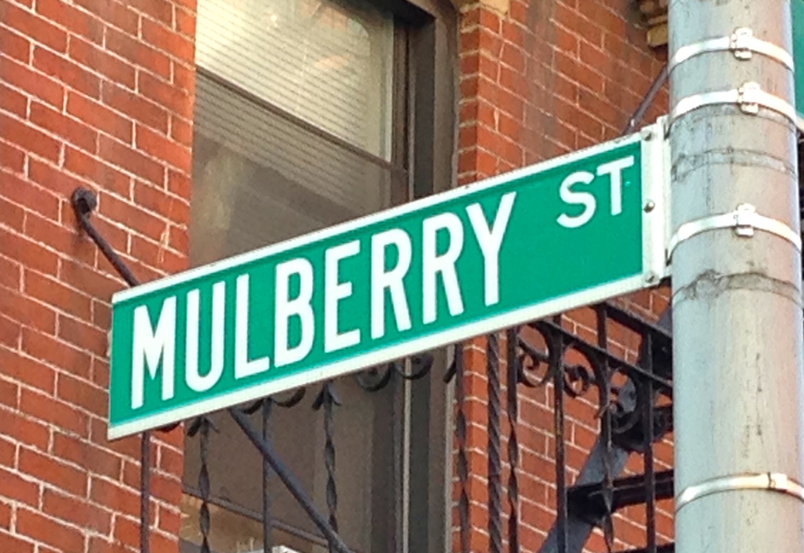 133 Mulberry Street, Unit 5A Manhattan, NY 10013 - Photo 12 of 15 a street sign on a building