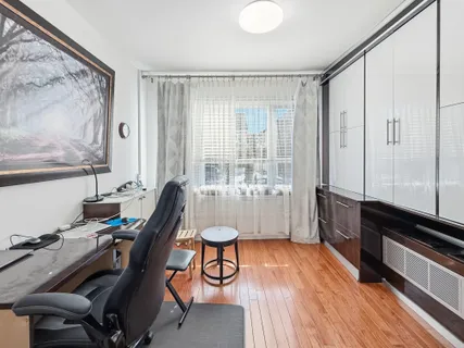 a view of a workspace with furniture and a window