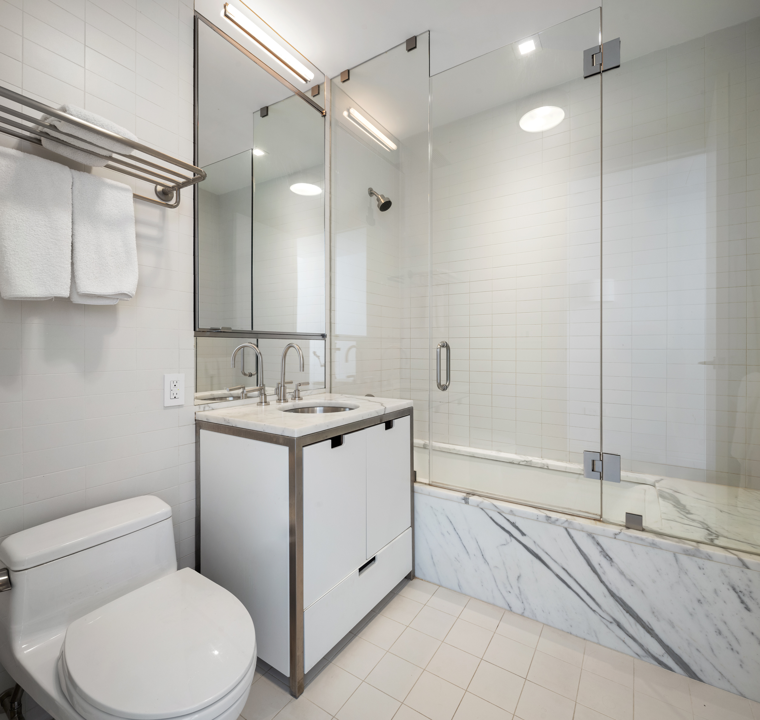 350 West Broadway, Unit 7FL Manhattan, NY 10013 - Photo 12 of 17 a bathroom with a granite countertop sink a toilet and bathtub