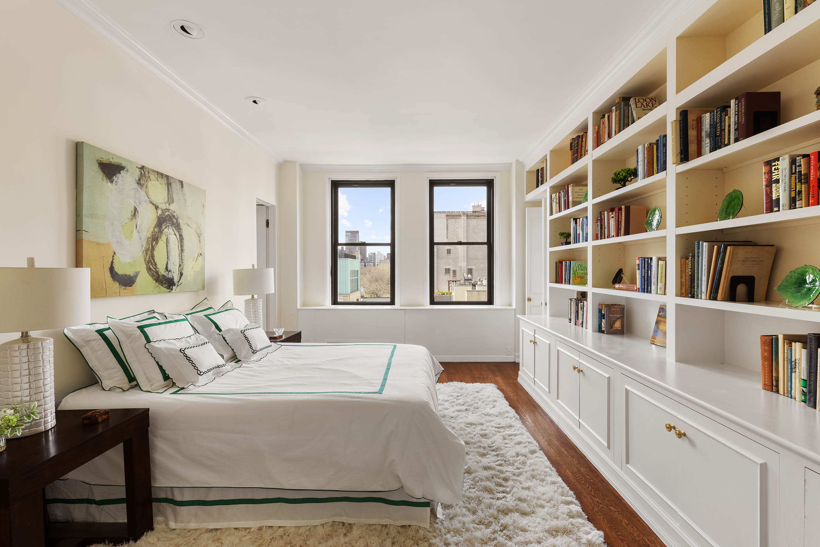 33 East 70th Street, Unit 9C Manhattan, NY 10021 - Photo 8 of 12 a bedroom with furniture and a book shelf