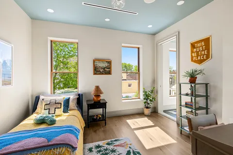 a bedroom with furniture and a window