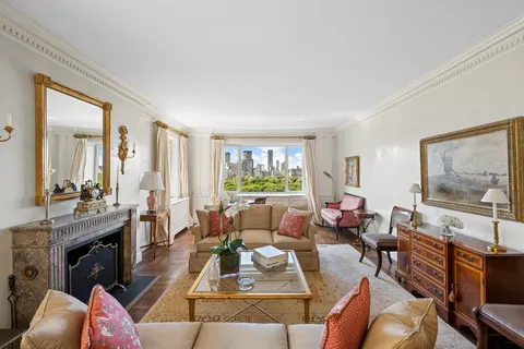 a living room with furniture large window and a flat screen tv