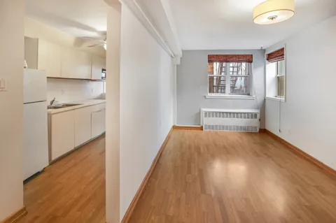 a view of a room with wooden floor and window