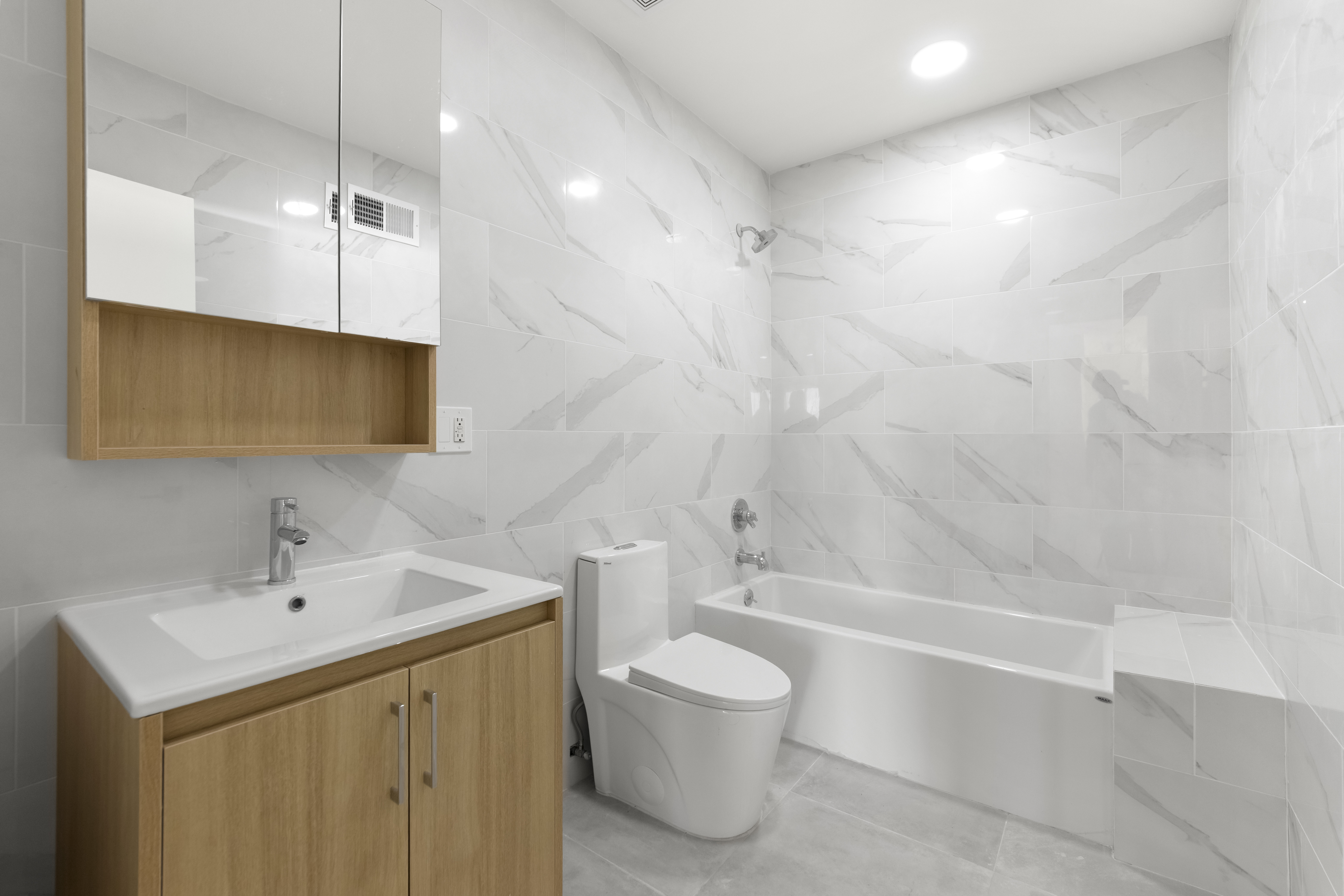 3112 Emmons Avenue, Unit 3132-2 Brooklyn, NY 11235 - Photo 5 of 11 a bathroom with a sink a toilet and shower