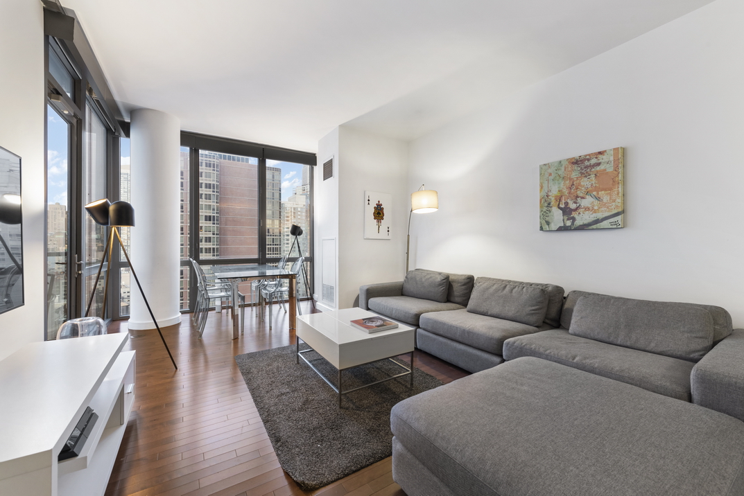 101 West 24th Street, Unit 26A Manhattan, NY 10011 - Photo 1 of 21 a living room with furniture wooden floor and a large window