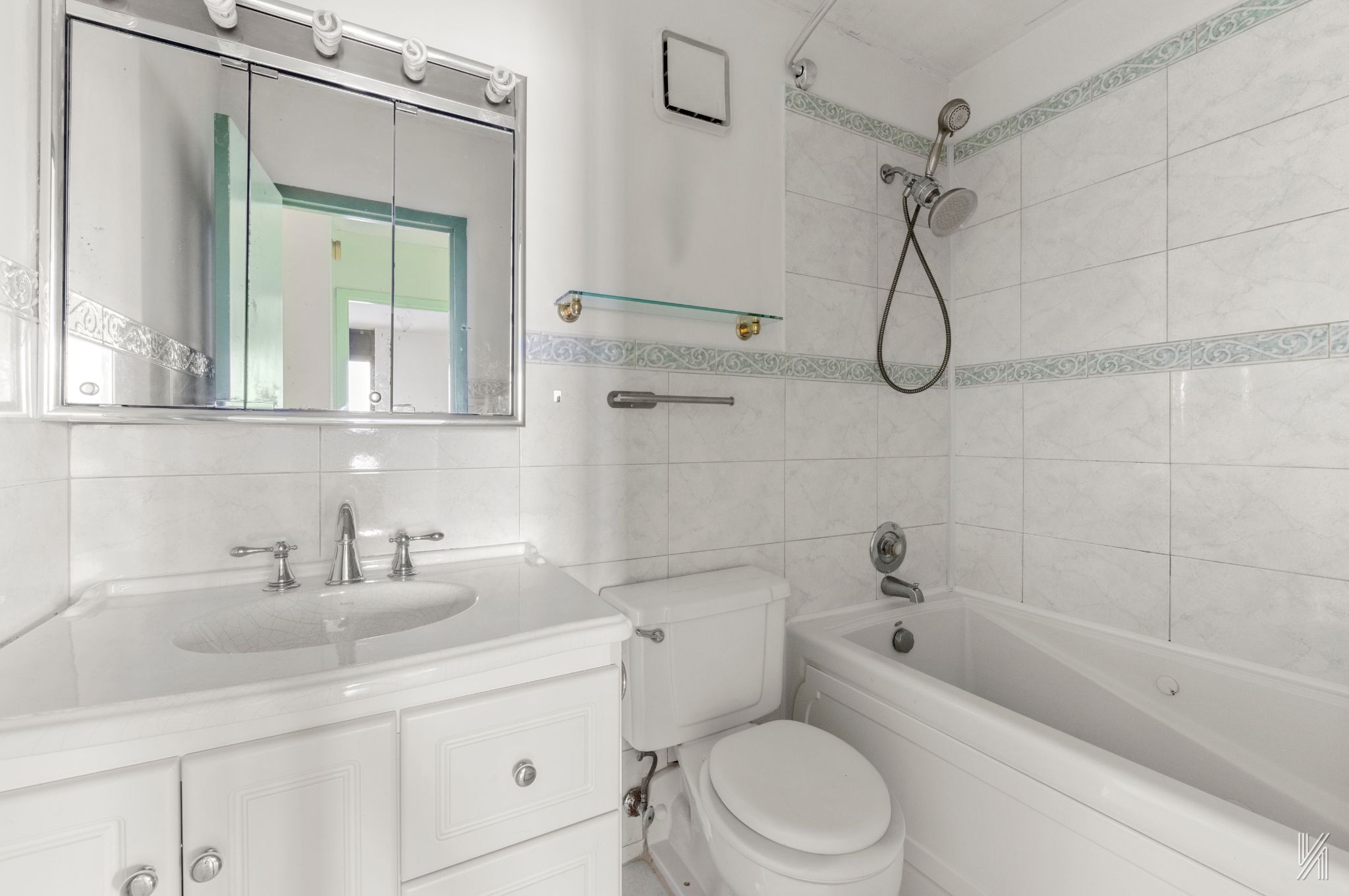 25-40 Shore Boulevard, Unit 4R Queens, NY 11102 - Photo 8 of 11 a bathroom with a sink a toilet and a bathtub
