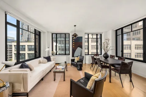 a living room with furniture and large windows