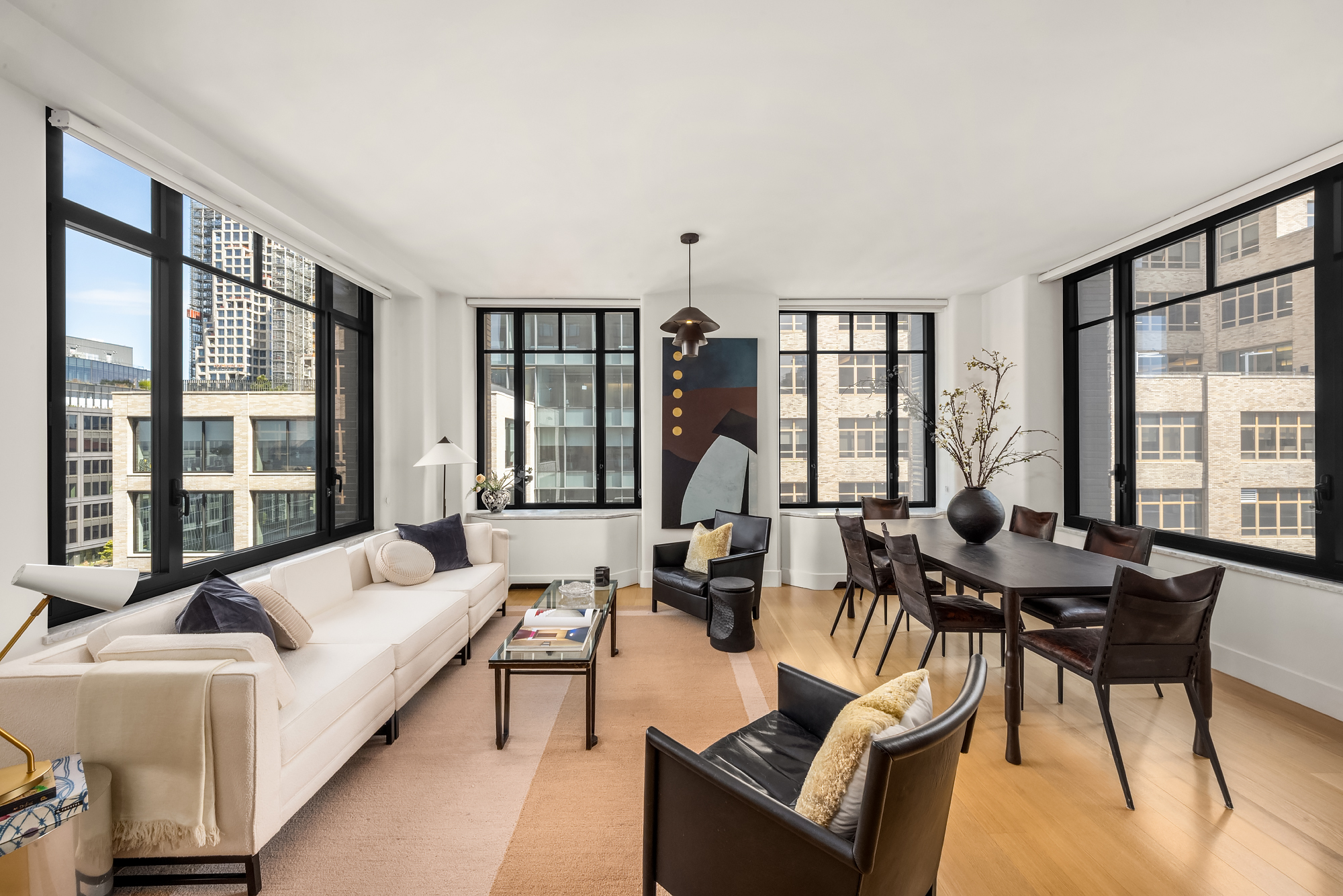 110 Charlton Street, Unit 17E Manhattan, NY 10014 - Photo 4 of 20 a living room with furniture and large windows