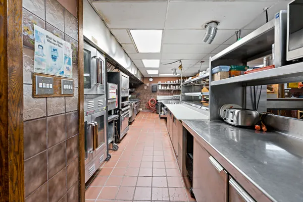 a stove top oven sitting inside of a kitchen