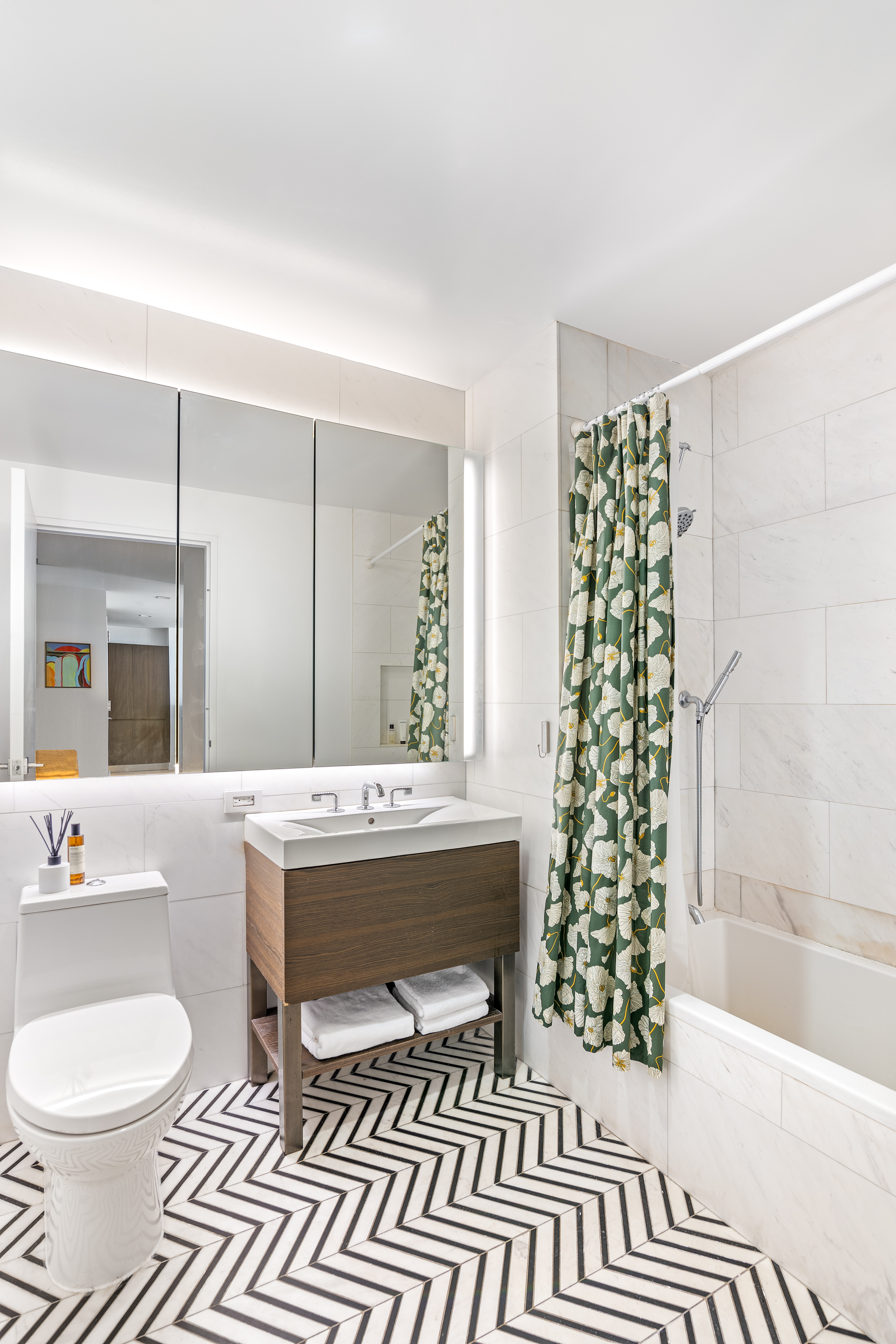 100 Avenue A, Unit 2B Manhattan, NY 10009 - Photo 7 of 8 a spacious bathroom with a sink and a mirror