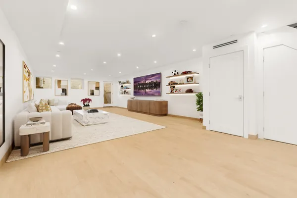 a living room with furniture and white bed