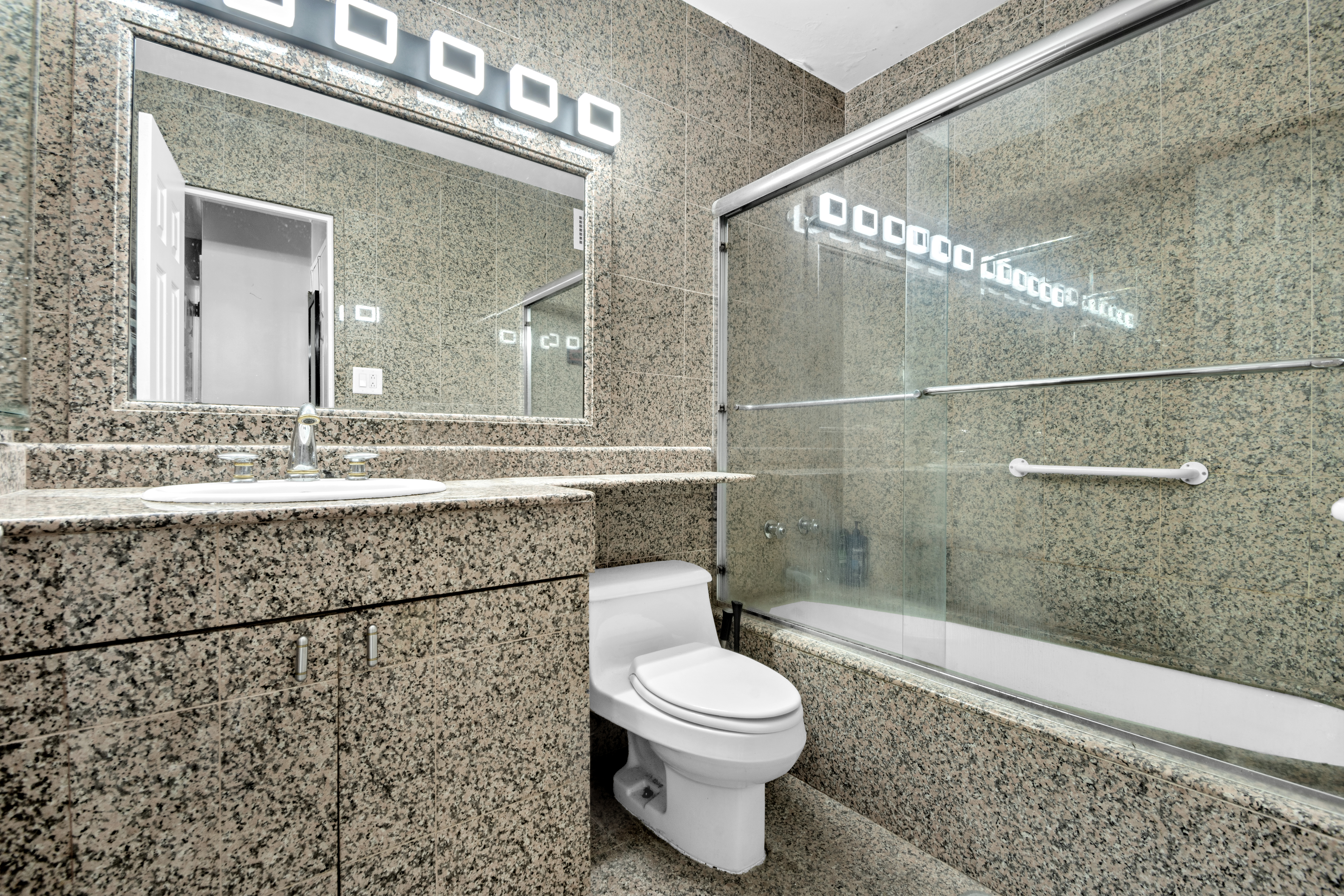 303 East 57th Street, Unit 17E Manhattan, NY 10022 - Photo 6 of 6 a bathroom with a toilet sink and shower