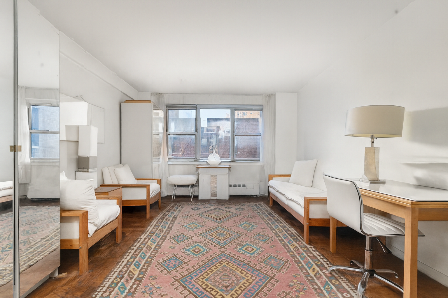 333 East 79th Street, Unit 7P Manhattan, NY 10075 - Photo 2 of 13 a living room with furniture and a large window