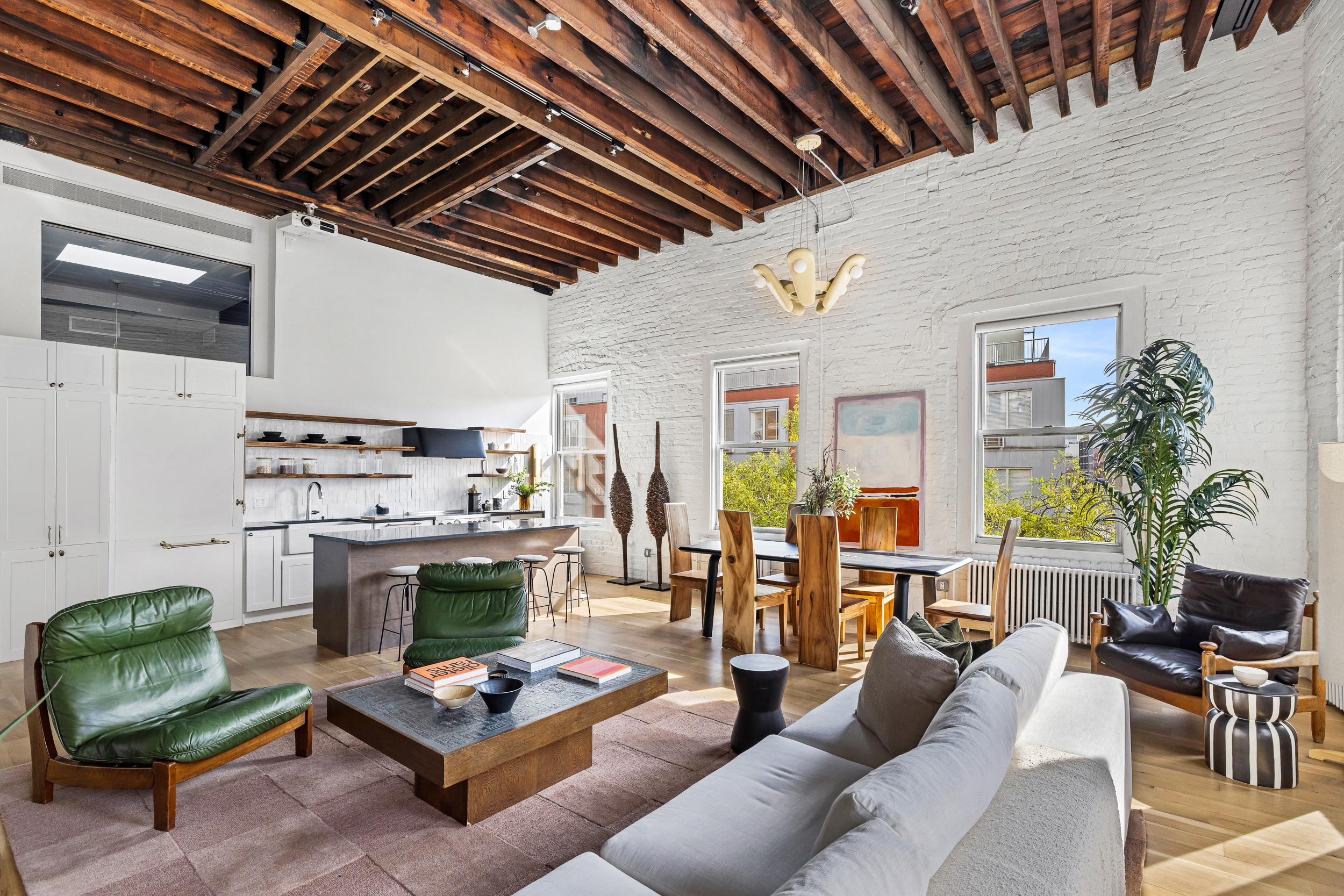 325 Bowery, Unit PH Manhattan, NY 10003 - Photo 3 of 17 a living room with furniture and a fireplace